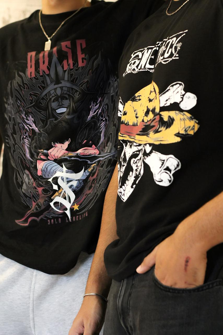 Two black t-shirts with graphic designs worn by people, featuring a dark angel and a yellow hat design.